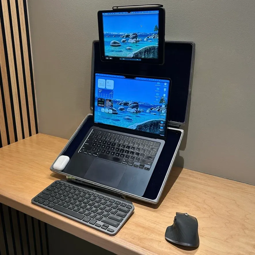 Prototype holding a laptop and a tablet on a wooden desk, with a separate keyboard and mouse